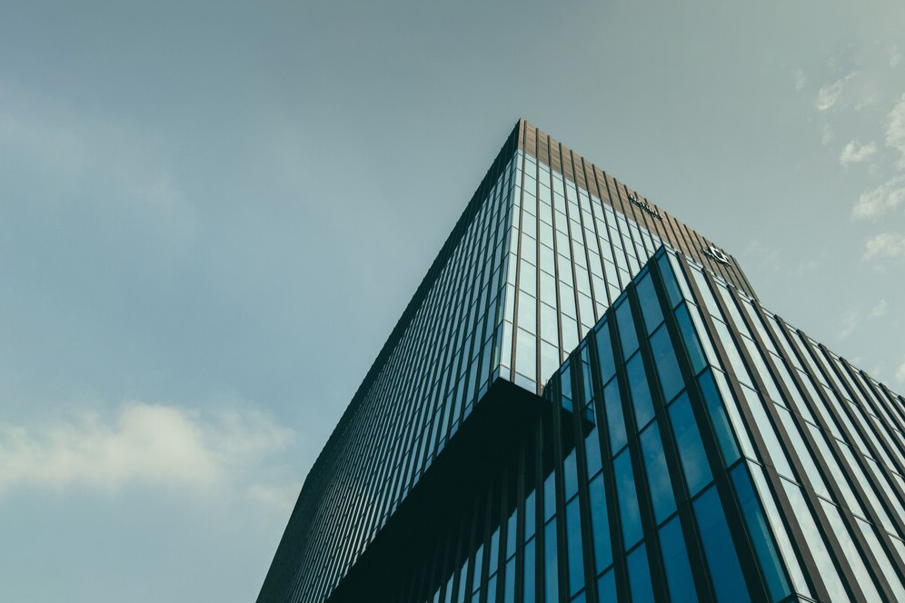 low-angle-view-building-glass-facade-beautiful-cloudy-sky_181624-6123